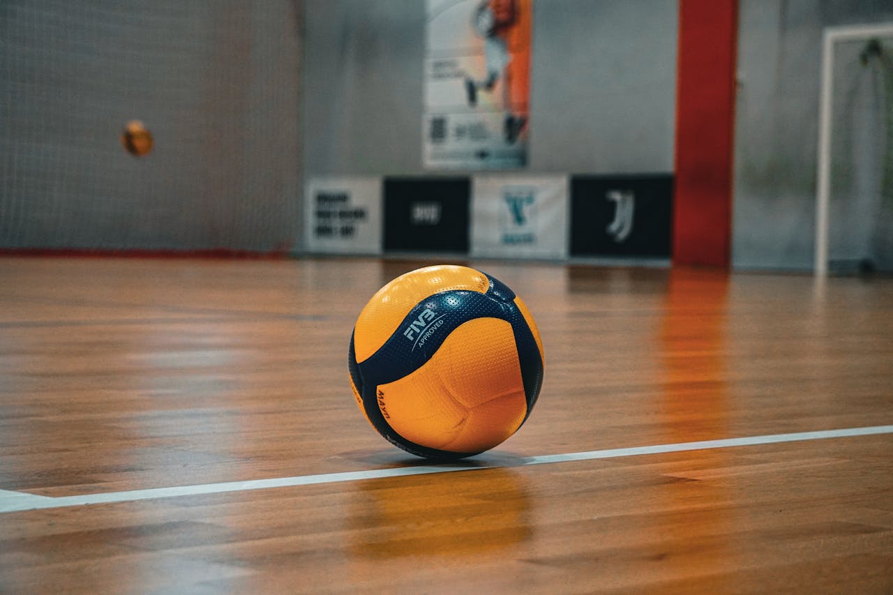Volleyball resting on a polished indoor court in Kyiv, perfect for sport-themed imagery.